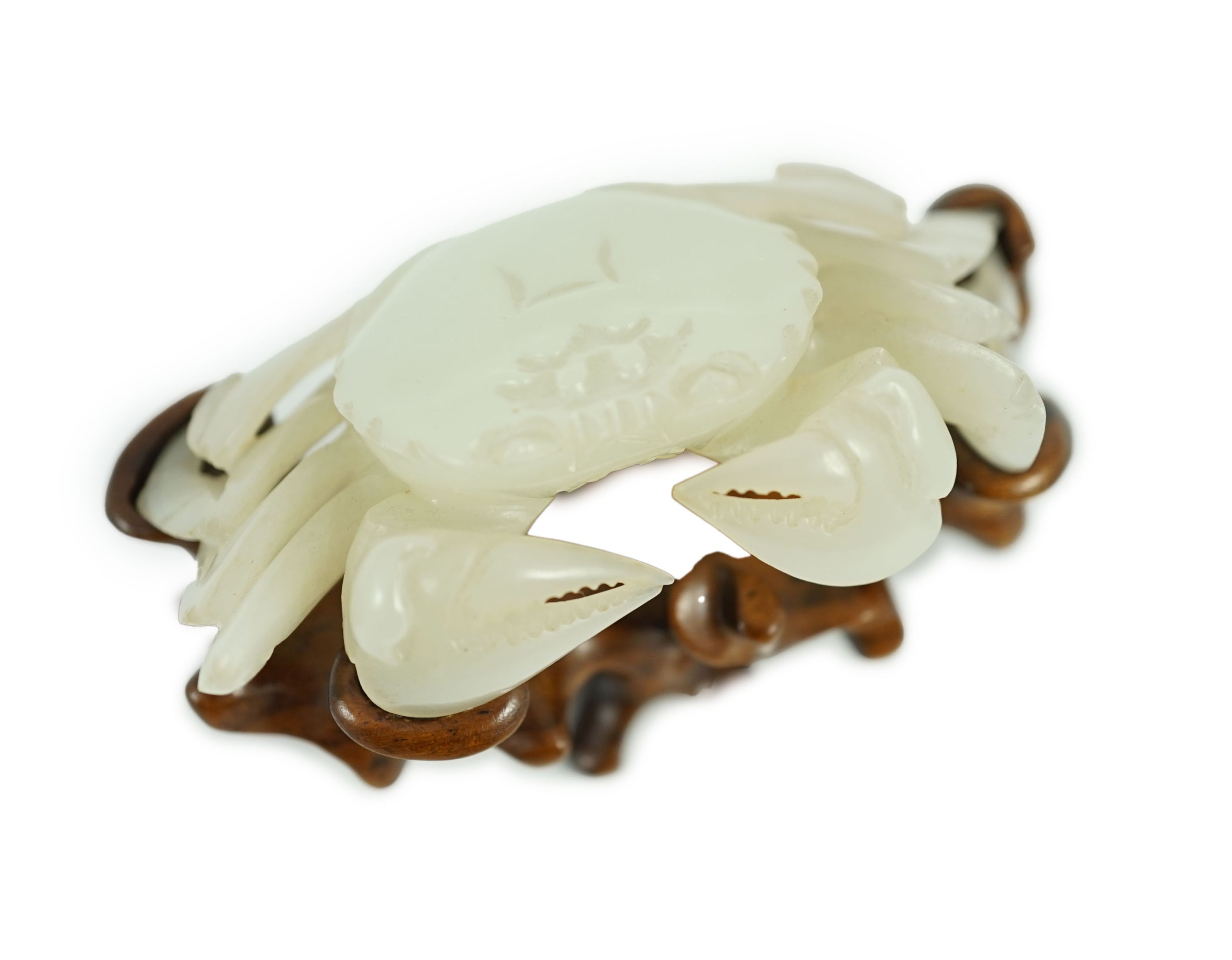 A Chinese pale celadon jade model of a crab, 20th century, 8.4 cm wide, wood stand